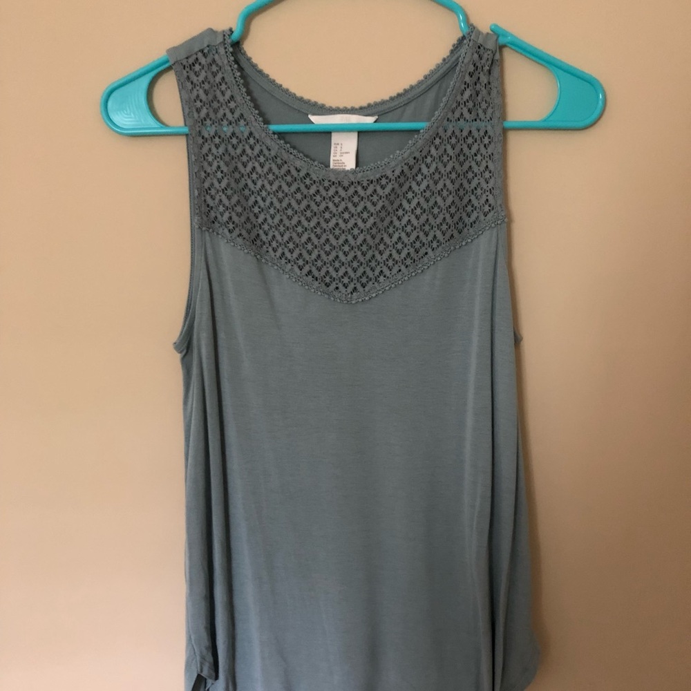 Light teal sleeveless top with lace-like detailing